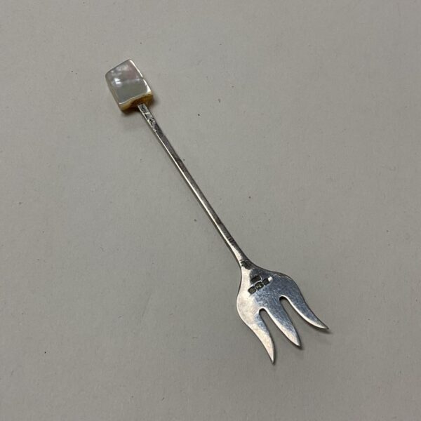 Vintage sterling silver oyster fork with mother of pearl handle.