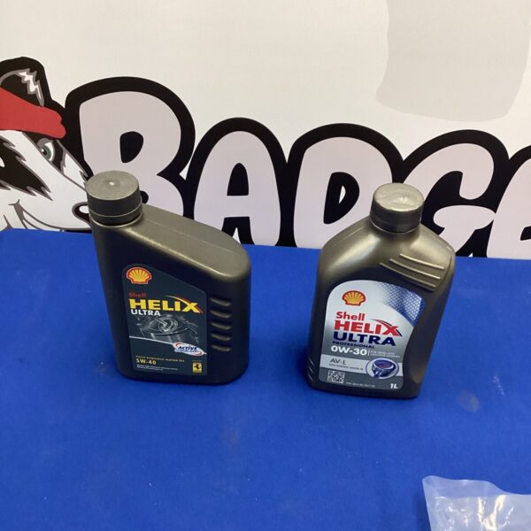 Two bottles of Shell Helix 5W-30 motor oil for vehicle maintenance.