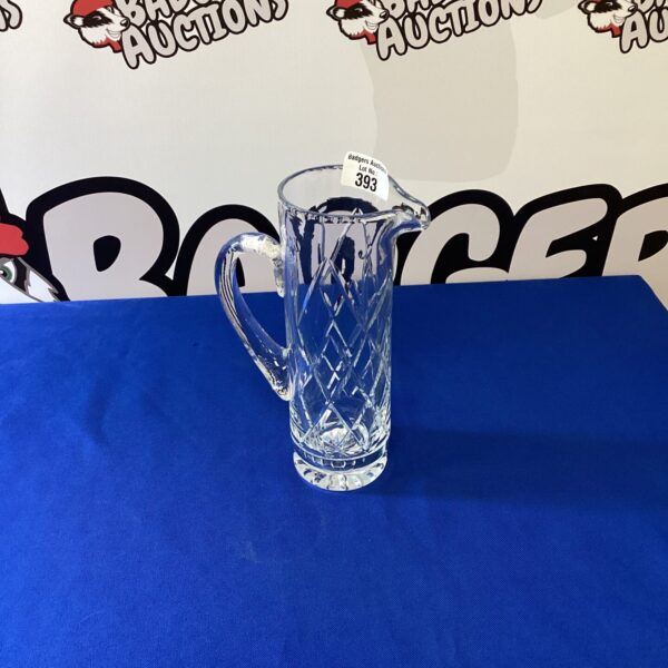 Elegant vintage crystal pitcher with intricate cut glass design.