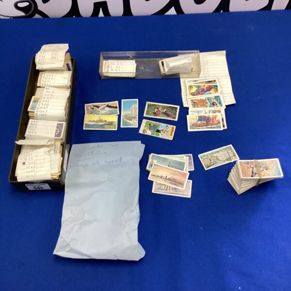 Vintage cigarette cards depicting Australia and buccaneers in a collectible lot.
