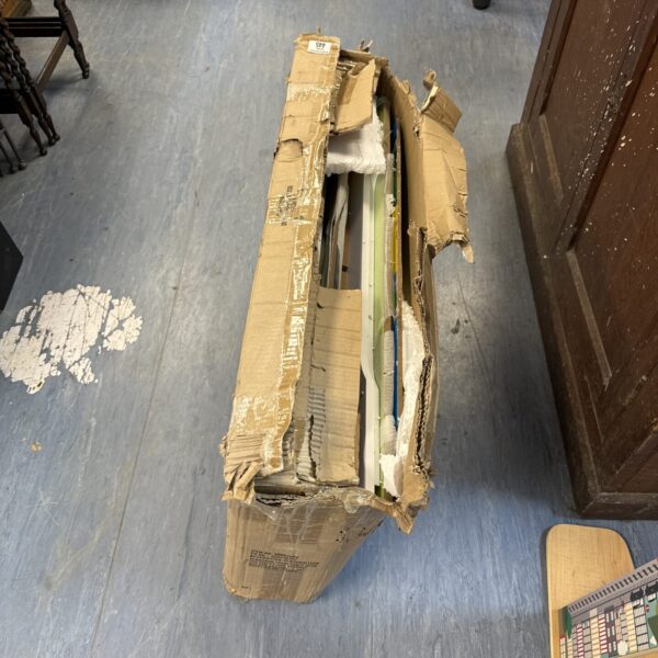 Open box showing a dinosaur train table and its contents.