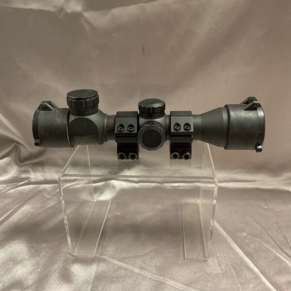 Vintage telescopic gun sight for rifles, showing adjustable focus.