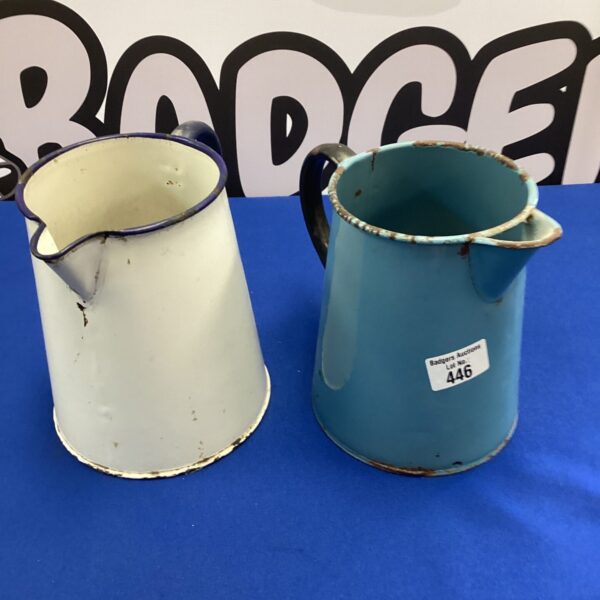 Pair of vintage metal jugs with enamel finish.