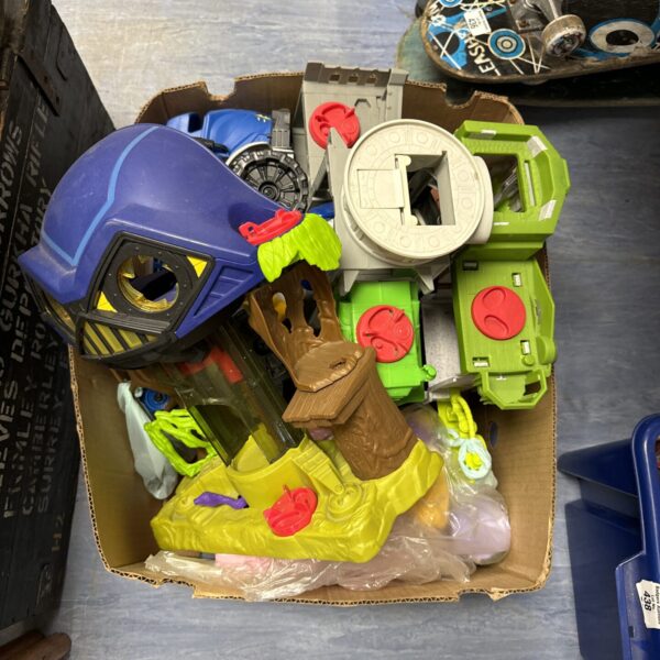 Colourful mixed toy lot with Imaginex Bathouse and action figures.