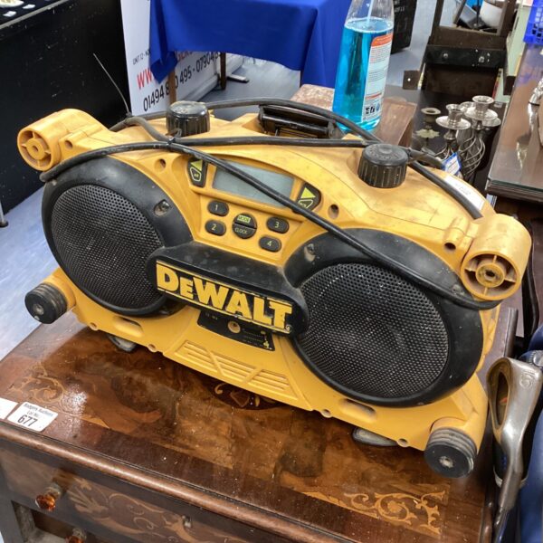 Yellow and black Dewalt DCR015 site radio on a workbench.