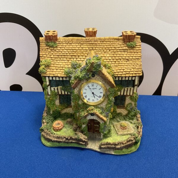 Detailed Widdop country house miniature clock with floral accents.