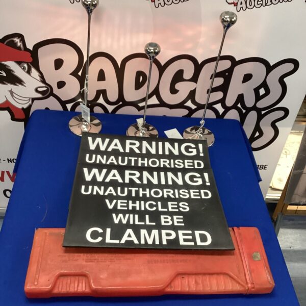 Clamping warning signs and car warning triangle for road safety.