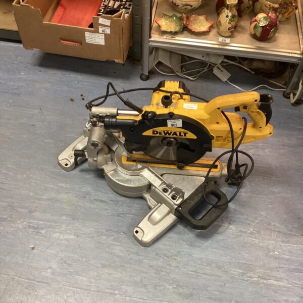 Used Dewalt chop saw for cutting metal in a workshop setting.