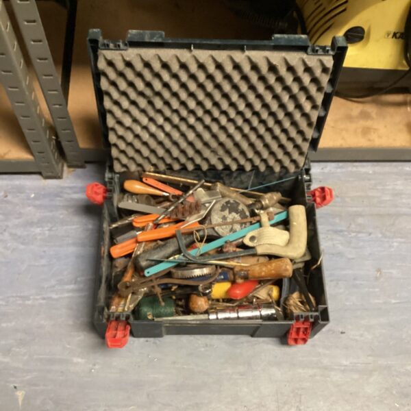Open carrying case filled with a mixed lot of hand tools.