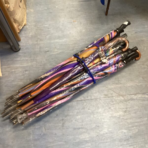 New colourful umbrellas in a bulk lot for rain protection.
