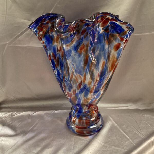 Vibrant Murano style spatter glass vase with red and blue patterns.