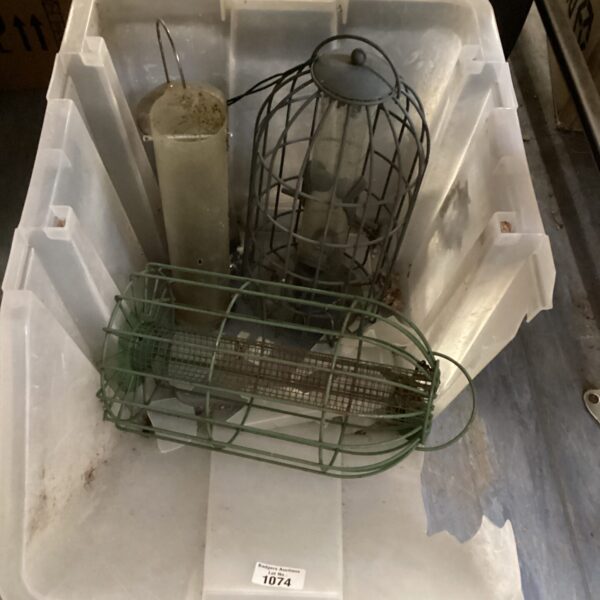 Selection of metal and plastic bird feeders in a plastic container.
