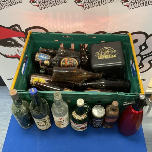 Vintage bottle collection with soda syphon and ice bucket.