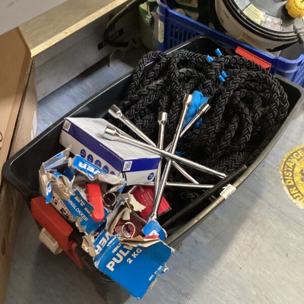 Mixed lot of towing rope and wheel brace for vehicle maintenance.