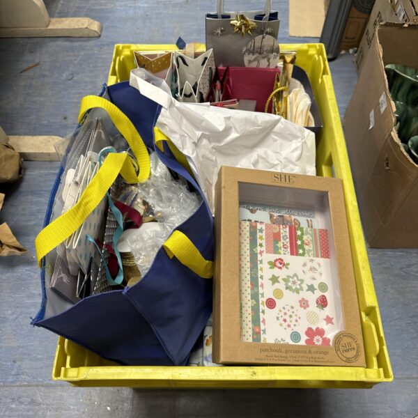 Colorful gift wrapping bundle with ribbon and bottle bags.