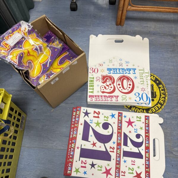 Boxes of 21st and 30th birthday bunting for party decorations.