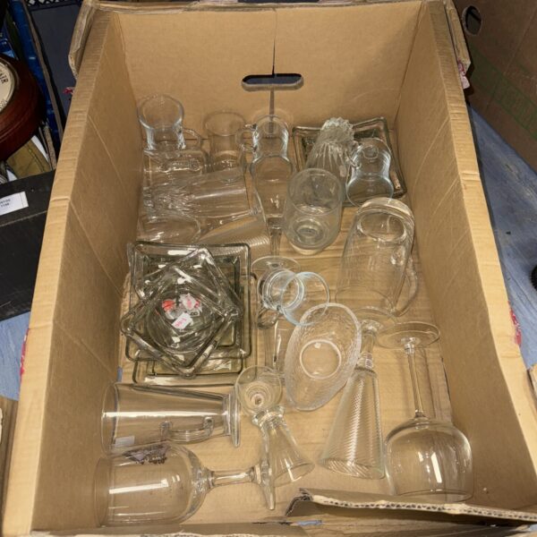 Mixed glassware lot with assorted drinking glasses and coasters.