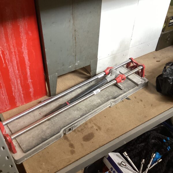 Large Rubi tile cutter in used condition, missing a blade.