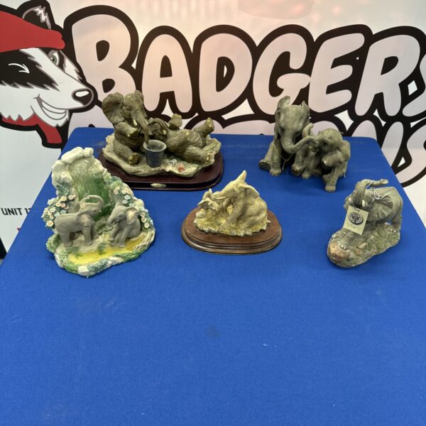 A lot of resin elephant ornaments in various poses and styles.