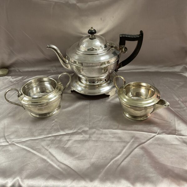 Vintage silverplate tea set by V Ltd with teapot, sugar bowl, and milk jug.