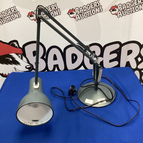 Grey Anglepoise lamp on a patterned background, adjustable task lighting.
