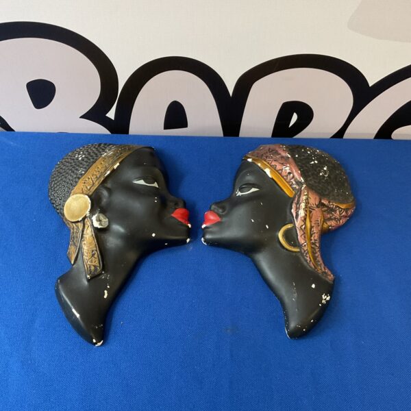 Vintage chalkware African heads, a collectible pair of wall sculptures.