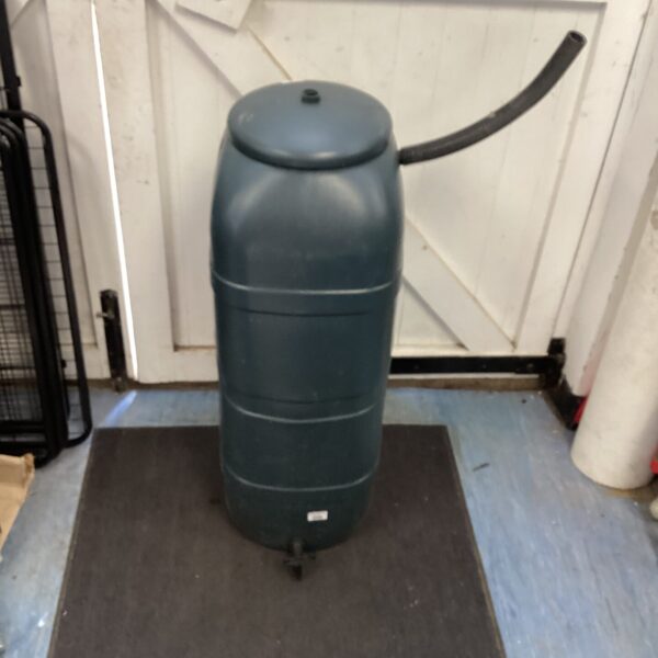 Dark green plastic water butt for garden rainwater harvesting.