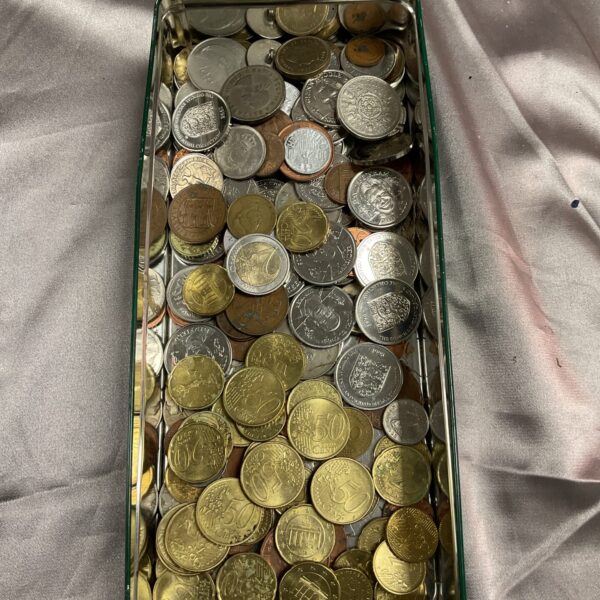 Assorted coin lot in a metal tin, mixed currency collection.