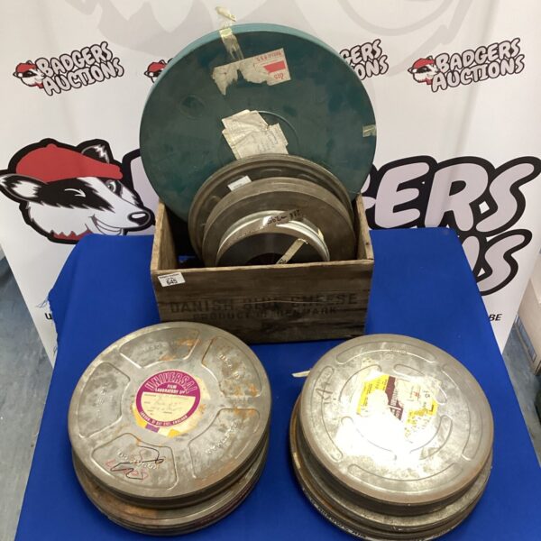 Lot of vintage movie reel cases with film inside.