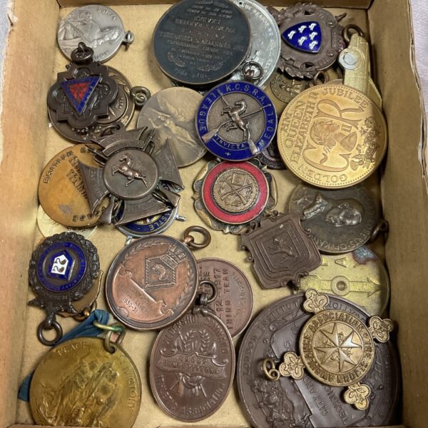 Vintage assorted shooting and military medals in a collection.