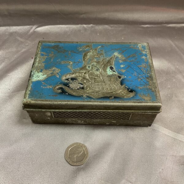 Vintage pewter cigarette box with a painted ship decoration.