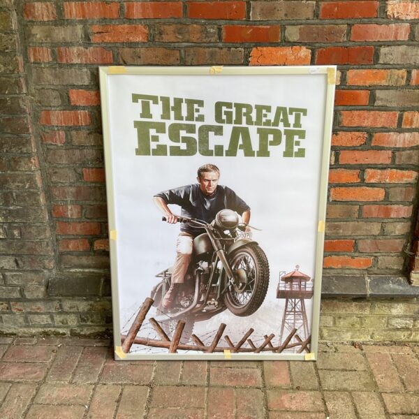 Vintage Great Escape poster featuring Steve McQueen on a motorcycle.