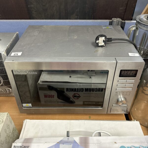 Front view of a used Russell Hobbs digital microwave oven.