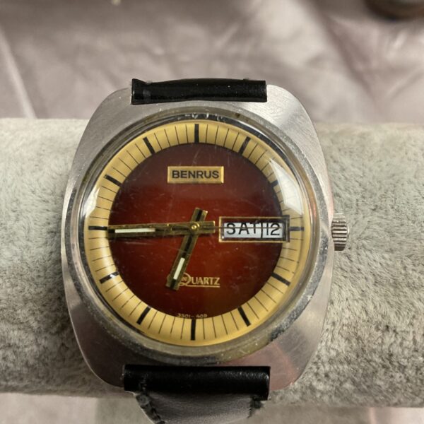 Vintage Benrus quartz watch with brown dial and hour markers.