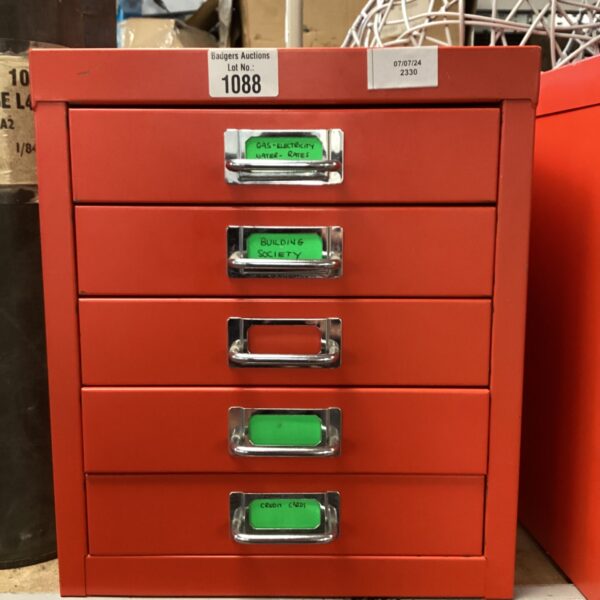 Side view of a red Ryman five-drawer filing cabinet.