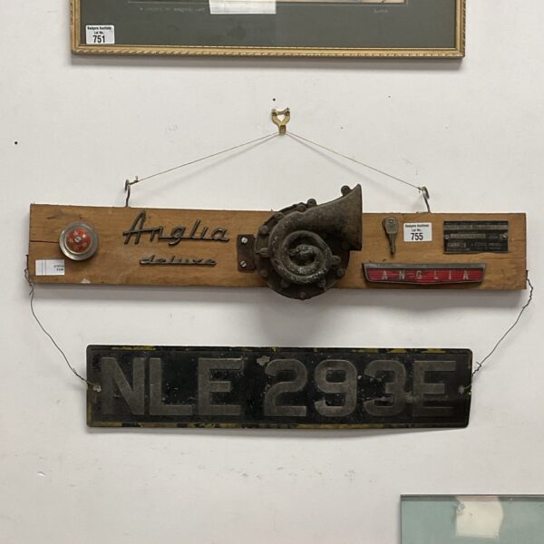 Vintage Ford Anglia number plate and badges for classic car restoration.