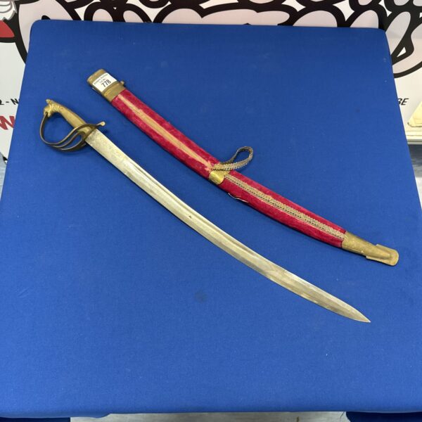 Antique Indian dress sword with ornate brass hilt and curved blade.