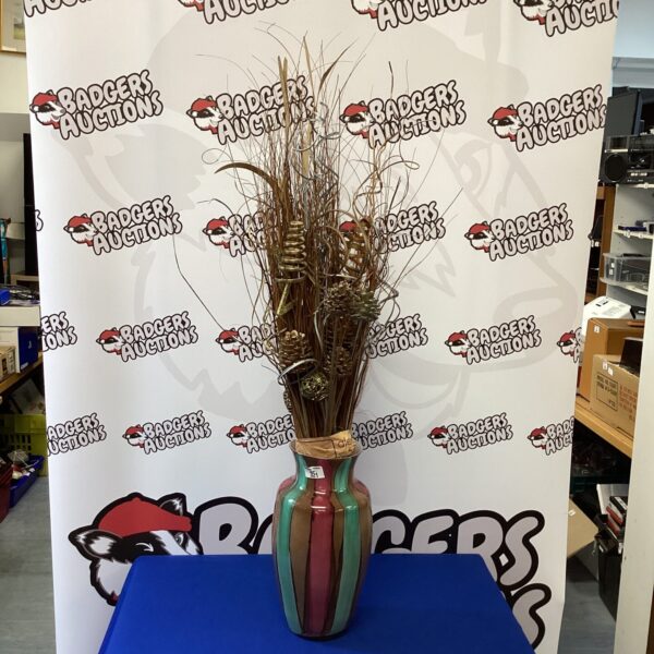 Large colourful Christmas vase with festive decorations for holiday display.