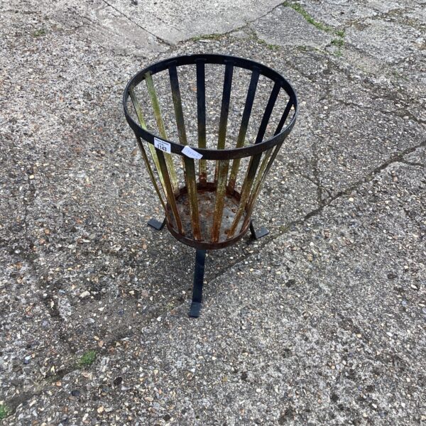 Rustic metal fire pit in a garden setting.