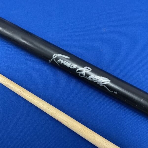 Close-up of Ronnie O’Sullivan’s signature on a black snooker cue.