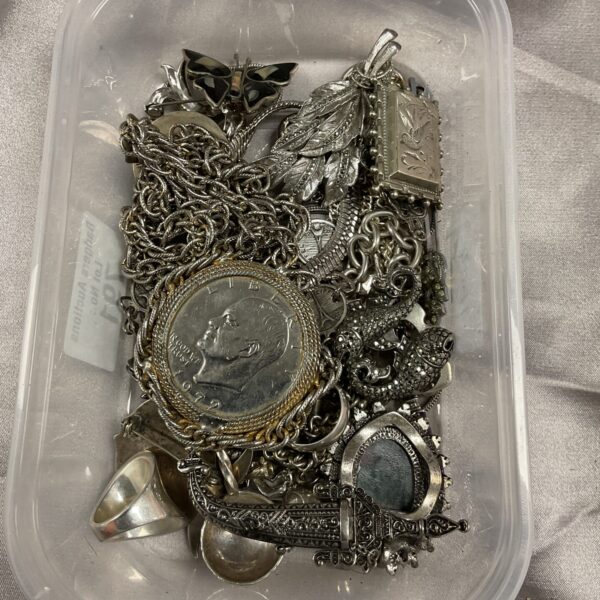 Mixed lot of white metal jewellery including a 1972 dollar necklace.