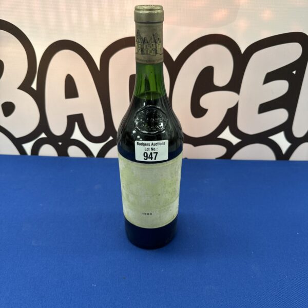 Vintage 1982 Chateau Haut Brion wine bottle with faded label.