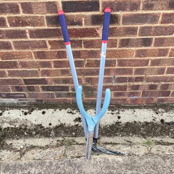 Long-handled garden shears for edging and landscaping tasks.