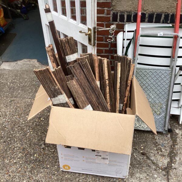 Box of salvaged lats for building restoration.
