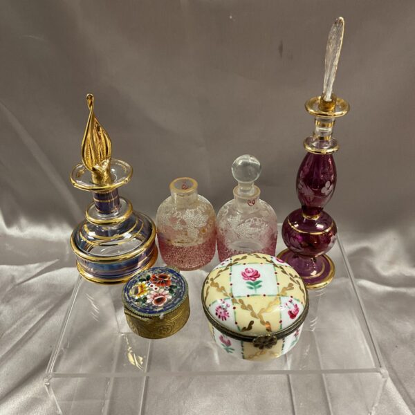 Antique miniature scent bottles and trinket pots in a collectible lot.