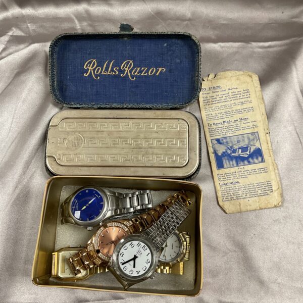 Vintage tin of ladies’ wristwatches and boxed Rolls Razor.