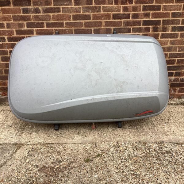 Grey Karrite roof box on a vehicle roof, showing exterior condition.