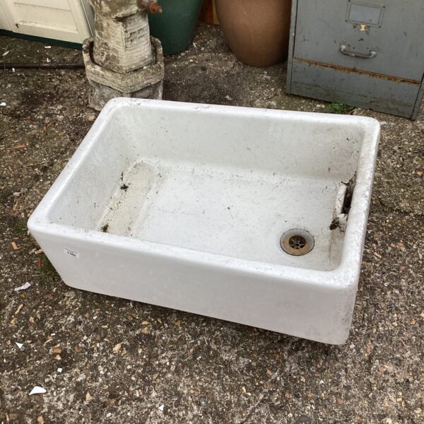 Vintage fireclay Belfast sink with drain, ideal for farmhouse kitchens.