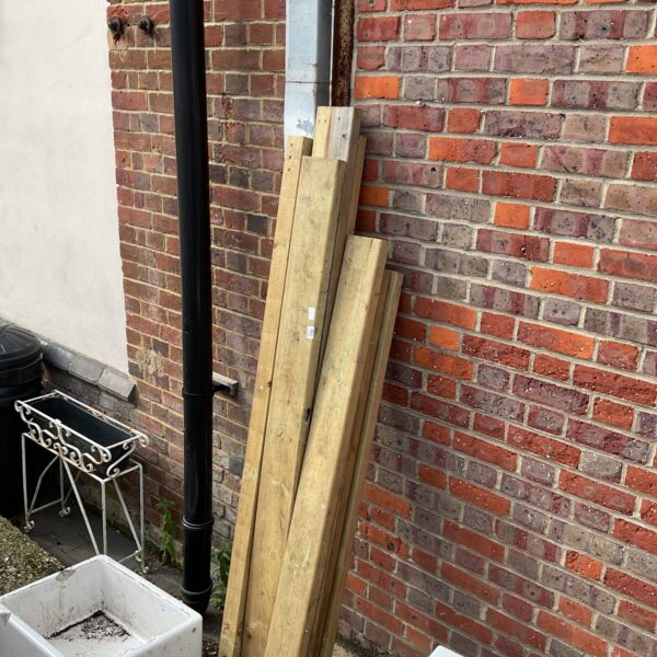 Mixed timber lot in a garden setting, ideal for DIY projects.