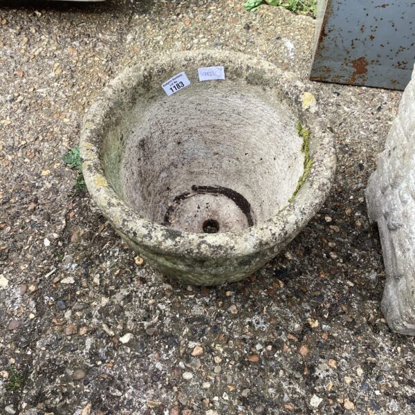 Weathered stone garden planter with a rustic, aged appearance.